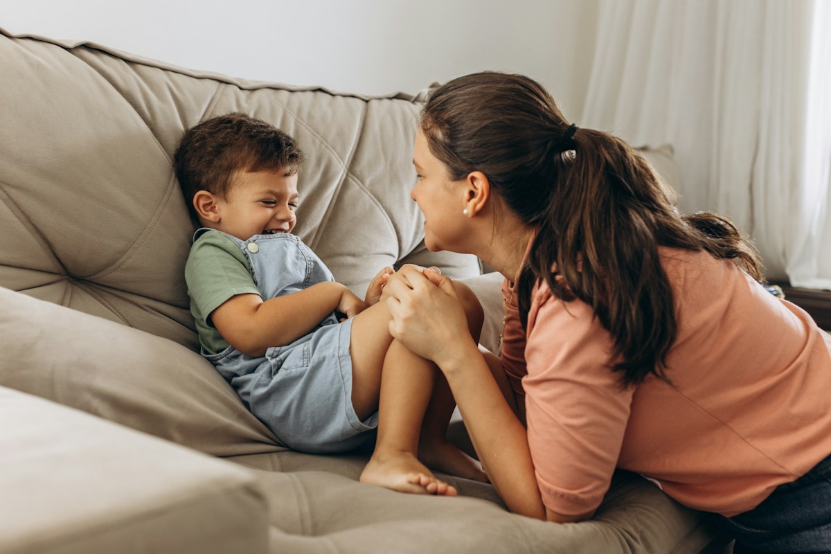 Mother and young child reconnecting at home.