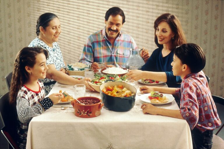 Family sharing a meal together around the dinner table.