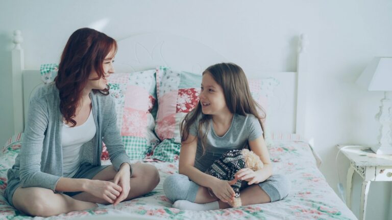 Mother and daughter sharing a quiet conversation at home.