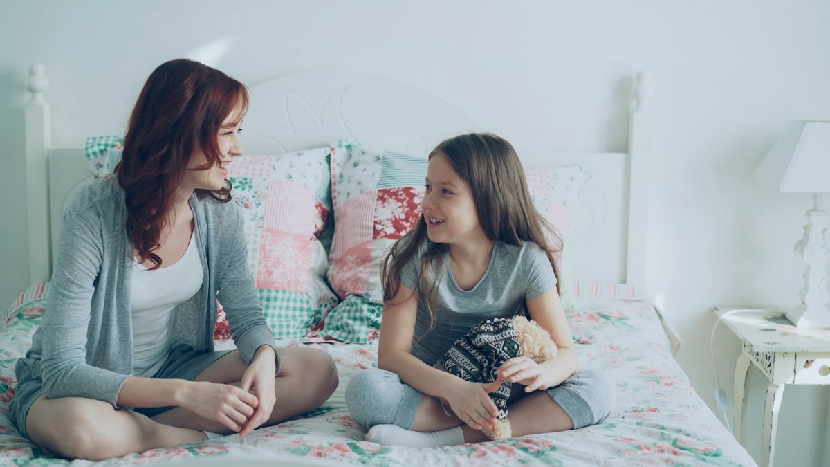 Mother and daughter talking together at home.