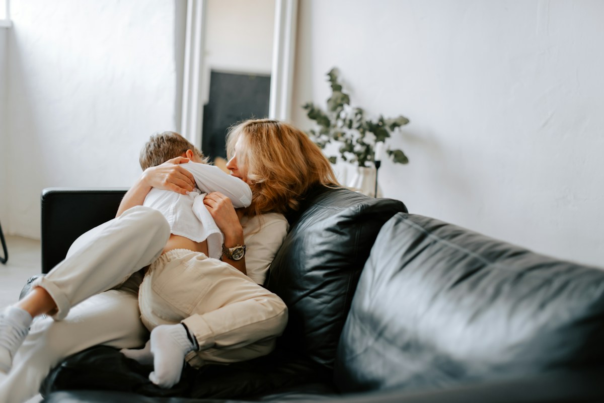 A new mother holding her baby at home.